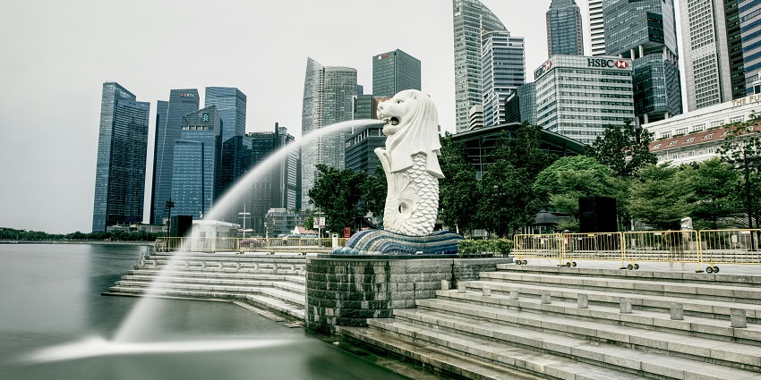 Merlion statue in Singapore with city skyline, popular places to visit in February near India.
