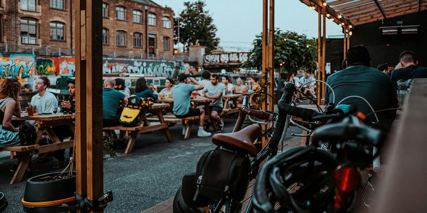 People enjoying local beers at Jopenkerk Brewery in the evening, fun things to do in Haarlem at night.