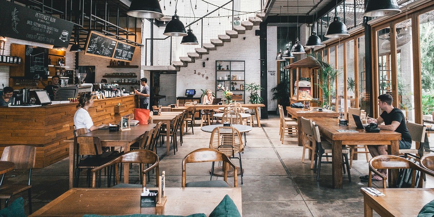 Rustic Cuban bar with wooden interiors, vibrant wall art, and classic vintage charm.