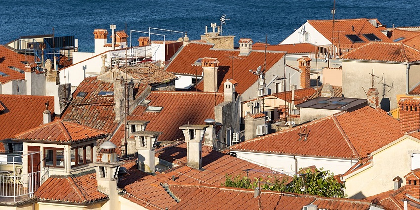 Piran’s red rooftops and Adriatic Sea viewed from St. George’s Church in Slovenia.