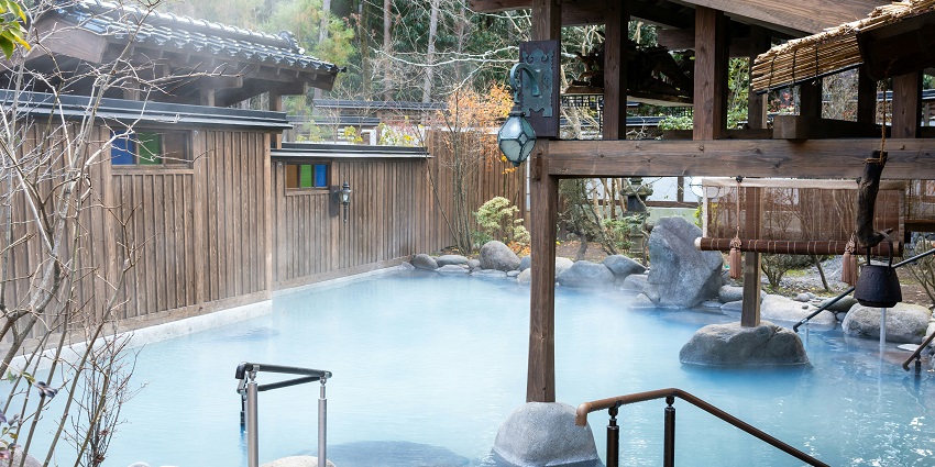 Indian Hot Springs is nestled among mineral pools and is surrounded by forested hills.