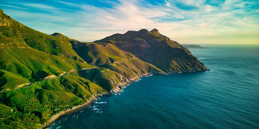 Scenic coastal view of Hout Bay with mountains and harbor in Cape Town, South Africa.
