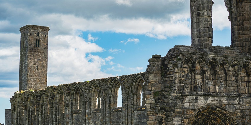 Sunset view of St Andrews Cathedral ruins under a clear blue sky, one of the best places to visit near Edinburgh.