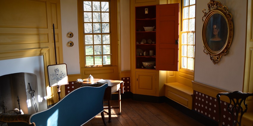 Historic front room at Peter Wentz Farmstead with 18th-century furniture and painted walls.