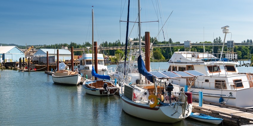 Toledo harbour with multiple white boats parked in the harbour and distant blue warehouses, one of the best things to see in Oregon Ohio.