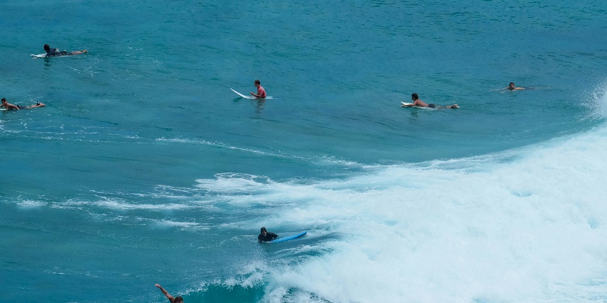 Taking surf lessons is one of the most playful things to do in Kuta for couples.
