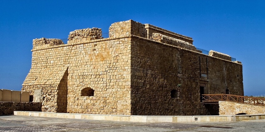 A view of the historic Castle in Paphos standing by the sea under a clear sky.