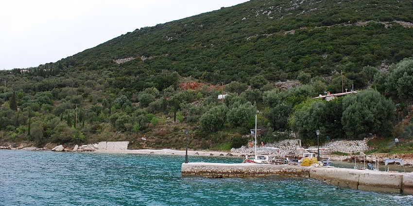 Coastal view of Piso Aetos on Ithaca with blue sea, ships, and hills in the background.