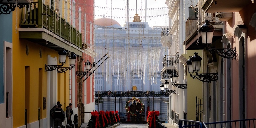Colorful street with festive lights, hanging decorations, and wreaths, one of the best things to see in Old San Juan.