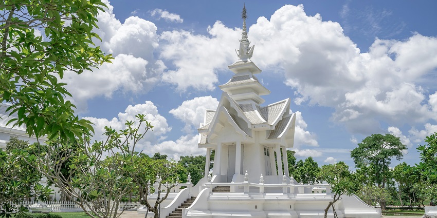 Phnom Da Temple with an ancient stone architecture set atop a hill in a rural landscape.