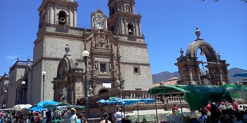 Outside the Basilica of Our Lady of the Rosary, with its grand structure and people gathered.