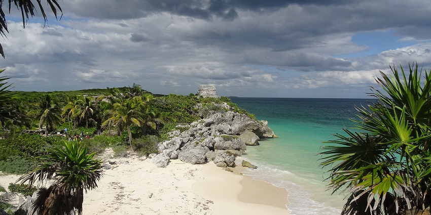 Ancient stone ruins at Tulum near the coast, with surrounding greenery, one of the top places to visit near Cancun.