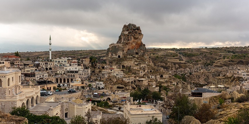 Ortahisar Castle in Cappadocia, Turkey, is carved into a tall, rugged rock formation.