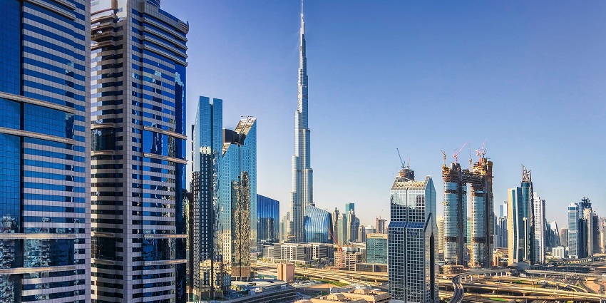 Burj Khalifa towers over the Dubai skyline with clear blue skies in the background.