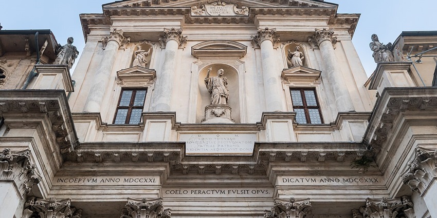 The front facade of Saint Cajetan church in Vicenza with multiple detailed statues, one of the best places to visit near Venice.