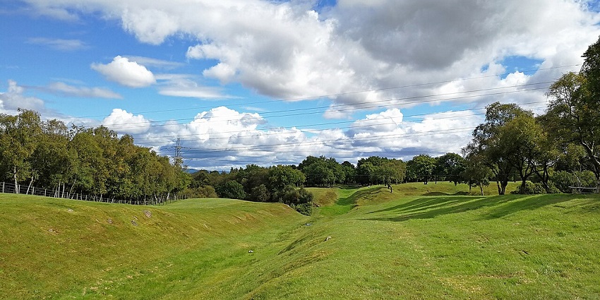 Antoninus Wall near Bonnybridge with grassy terrain and a walking path, one of the things to do in Falkirk.