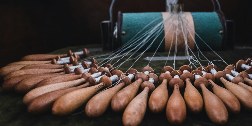 Traditional lace-making equipment is displayed at the National Bobbin Lace School.