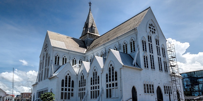 St. George’s Cathedral in Georgetown with traditional Christian architecture and a cross on top.
