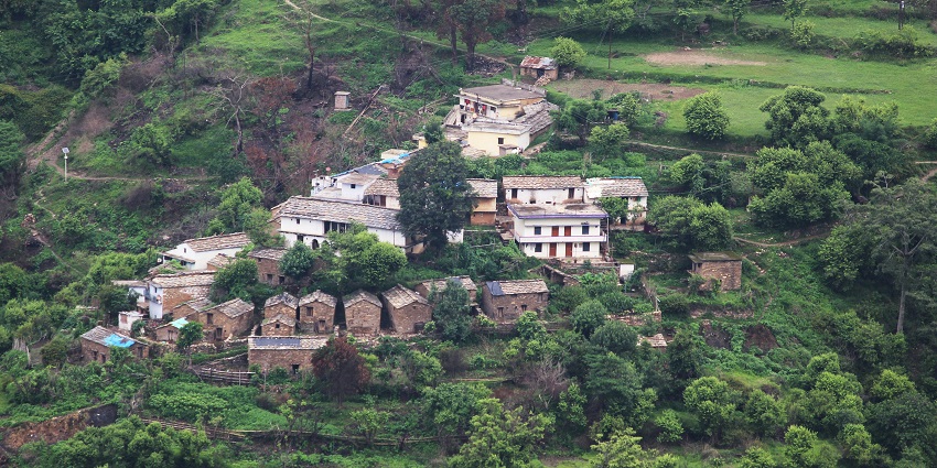 Aerial view of Wolleka Falasha village with houses surrounded by lush greenery.
