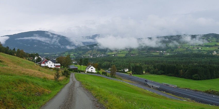 Walking pathway in Voss with distant roads, houses, greenery, and mountains, beautiful places to visit near Bergen.
