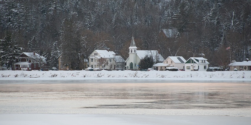 The charming village of Wakefield, Quebec with historic buildings and forested hills.