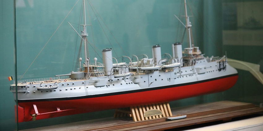 Titanic museum with a model of the ship and historical-style architecture.
