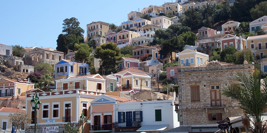 Neoclassical houses in Greece with multiple vibrant & colourful buildings and houses.
