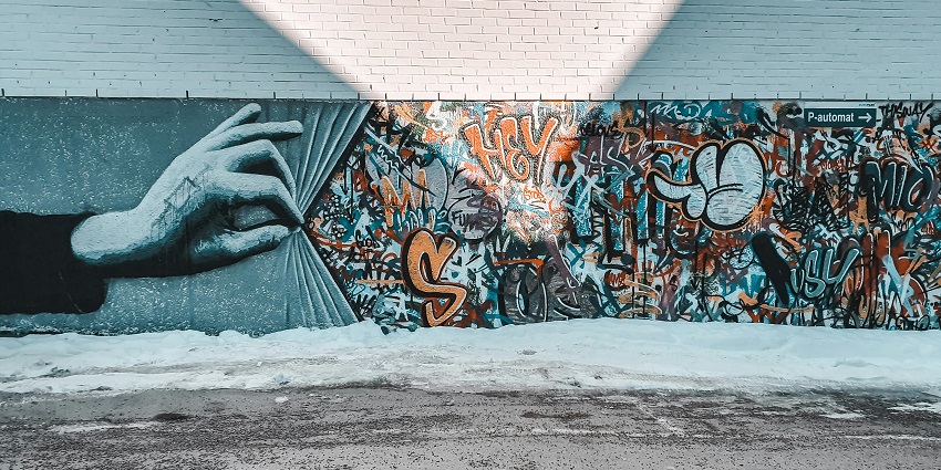 Explore colourful street art on white walls, one of the things to do in Paraguay.