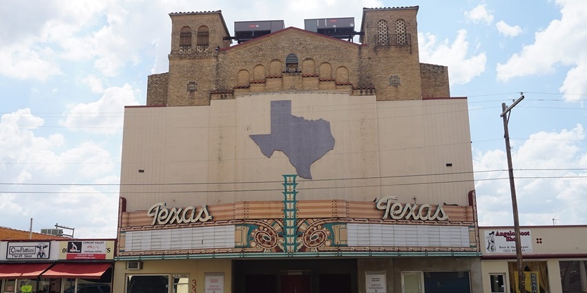 Interior of theater with rows of seats, upper balcony, and warm ambient ceiling lights, one of the best things to see in Orange Texas.