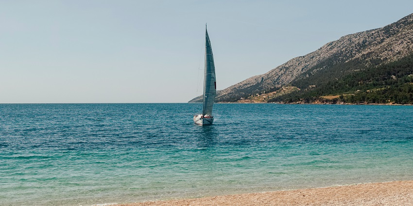 Zlatni Rat beach near Bol with golden pebbled shore and clear sea.
