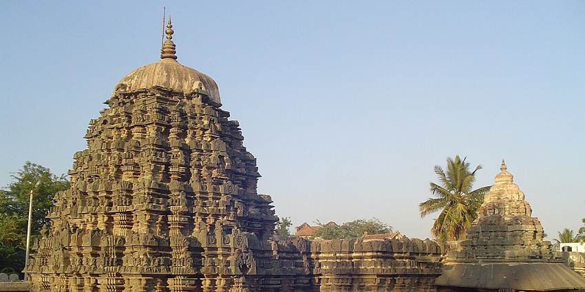 Amruteshwara Temple at Annigeri, with intricately carved stone walls and a stairway.
