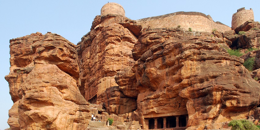 Badami caves with a unique rock formation entrance are among the best places to visit near Bijapur Karnataka.