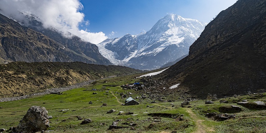 A scenic view of Pindari Glacier from Bageshwar under a clear sky.