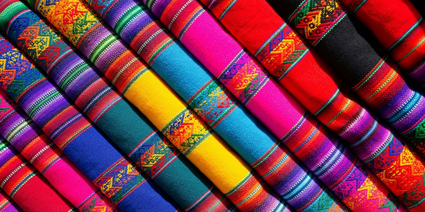 An amazing shot of a collection of colourful fabrics taken from a distance from above.