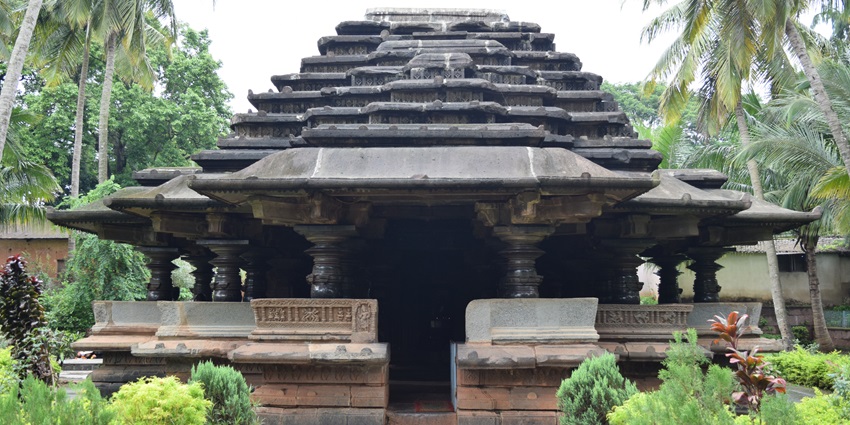 Ancient Jain temple in Belgaum, India, featuring stone architecture and detailed carving.