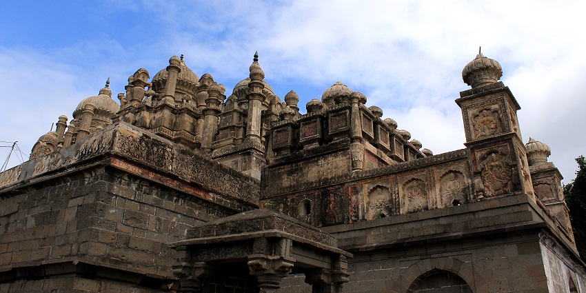 A corner view of the exteriors of Bhuleshwar Temple shows its weathered walls.