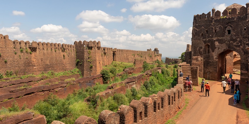 Tourists enjoy at the Bidar Fort near Gulbarga as patchy clouds hover above the fort, one of the best places to visit near Gulbarga.