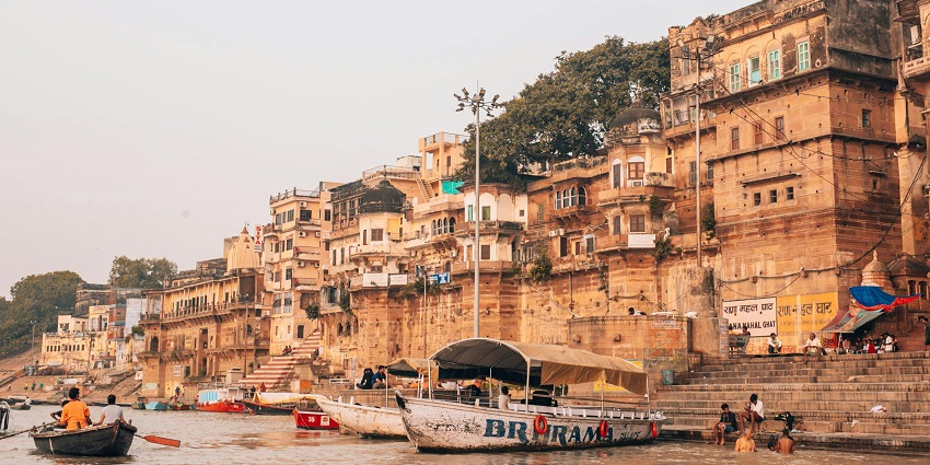 The boat is docked on the calm waters of the Ganges near Varanasi city.