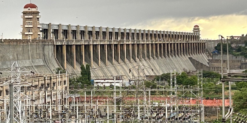 A huge Tungnbhadra Dam in Karnataka with an electrical grid in the foreground.