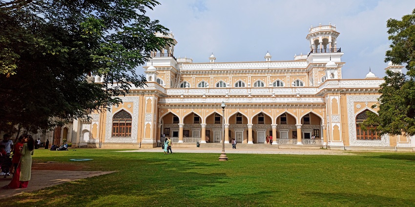 The front view entrance of Chowmahalla Palace in Hyderabad with arches and detailed brickwork.
