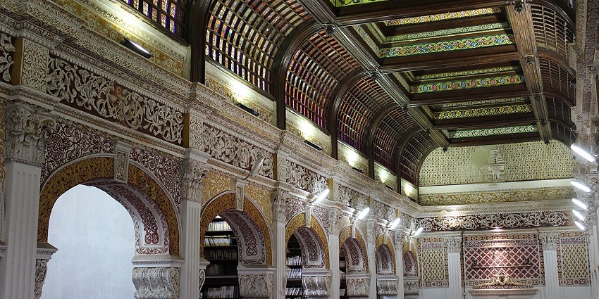 The intricately designed interior of Connemara Public Library with stained glass ceiling, one of the places to visit near Chennai in September.