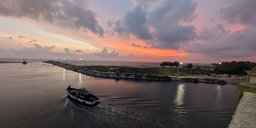 Muthalapozhi beach where the backwaters meet the Arabian Sea, offering a serene sunset view.