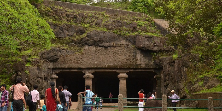 Tourists at the entrance to the Elephanta Caves, a site with rock-cut history on Elephanta Island.