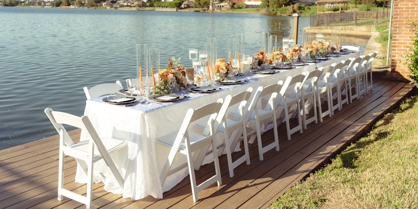 Restaurant dining table with multiple dishes & drinks on the table and mountains at a distance