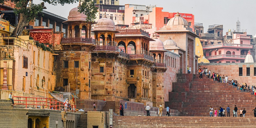 Varanasi ghat with stone stairs leading down to the water, a calm river scene at the ghats.