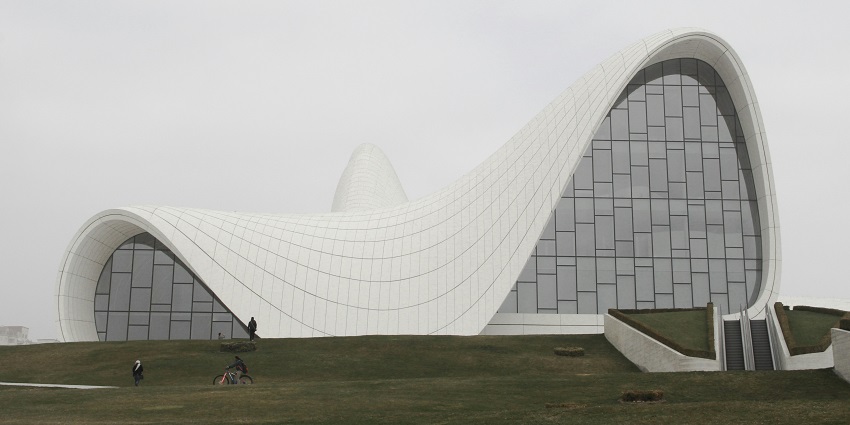 Modern architectural design by Zaha Hadid features flowing, futuristic curves and bold shapes.
