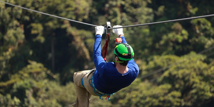 Ziplining activity at Hanuwantiya Adventure Zone surrounded by lush greenery.
