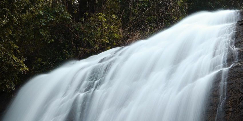 Hemagiri Waterfalls flowing over rocky surface, one of the top places to visit near Adichunchanagiri.