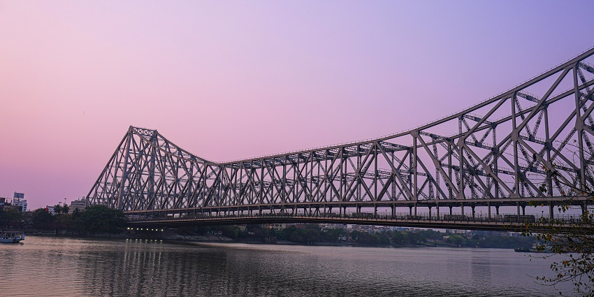 Howrah Bridge over Hooghly River at dusk, a top spot among places to visit near Howrah Station.