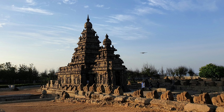 ISKCON Temple exterior featuring domes, carvings, and a peaceful architectural design.
